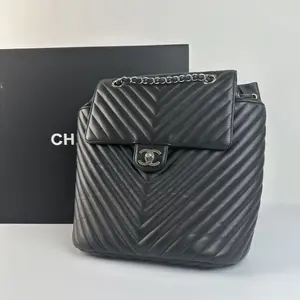 Pre-owned CHANEL Black Quilted Leather Backpack with Chain Strap and Logo Buckle
