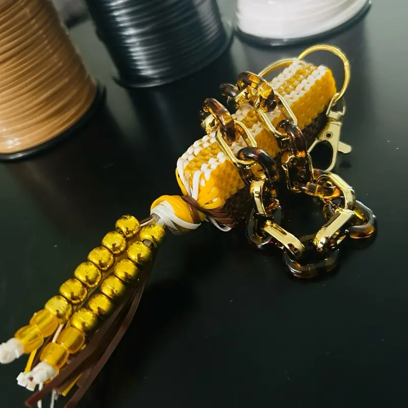Brown and Gold Boondoggle Colorful Bag Charm with Multiple Strings of Plastic Lanyard String Adorable Stitch Design Nostalgic Collectible with Cheetah print wristlet