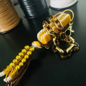 Brown and Gold Boondoggle Colorful Bag Charm with Multiple Strings of Plastic Lanyard String Adorable Stitch Design Nostalgic Collectible with Cheetah print wristlet