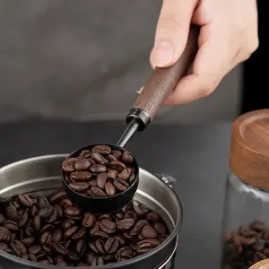 Vintage solid wood coffee scoop with a 10-gram capacity, featuring a walnut wood handle. Ideal for coffee, tea and more, it makes a perfect holiday gift.