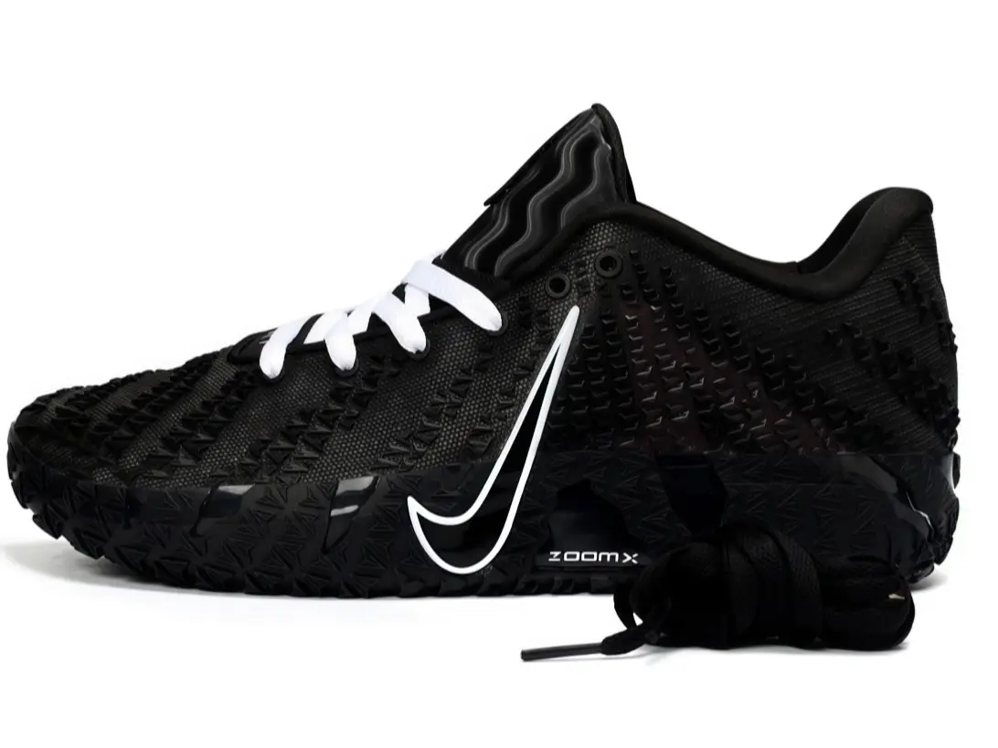 Unisex low-top performance basketball sneakers, textured black woven knit upper, white side graphic decoration, rugged deep-grip outsole, extra black shoelaces included, sleek black and white tone for court training and street outfits.