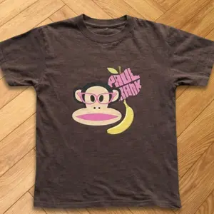Playful Monkey And Banana Brown Baby Tee With Colorful Cartoon Design