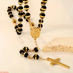 A trending retro-style stainless steel pendant necklace for 2026, featuring a black bead and cross design with a portrait motif—a classic vintage accessory suitable for both men and women for everyday wear.