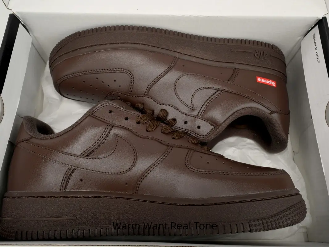 Solid dark brown leather low top casual sneakers with subtle small red logo accent, retro warm earth neutral street lifestyle footwear, all-match daily commuting & vintage streetwear wardrobe staple