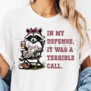 Funny Baseball Raccoon Graphic T-Shirt – White "In My Defense" Tee for Men Women | Viral Trendy Sports Humor Apparel | Premium Soft Cotton Top