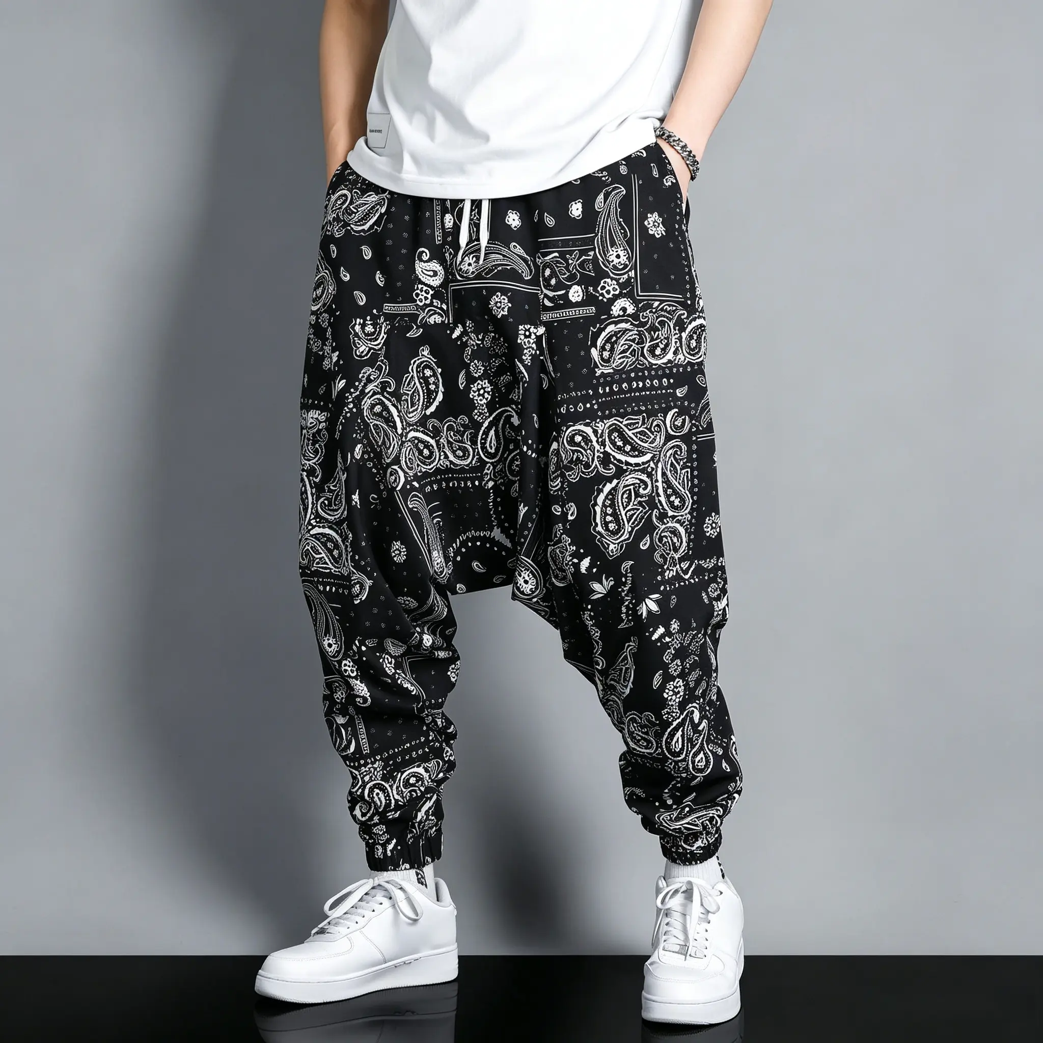 A loose, drapey high-waisted casual long pants with a nut print and a crotch seam; minimalist, relaxed everyday style. Black base with smooth, low saturation; wide cuffs and an elastic waistband. Soft fabric with a subtle drape; pure black with a soft con