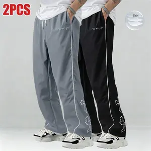 Men’s two-piece color-block sweatpants set featuring white side stripes and embroidered details; casual fitness wear; loose-fit joggers; trendy street-style running pants; drawstring waist; straight cut; polyester fabric