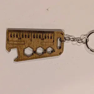 Ruler keychain with markings.