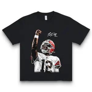 Shedeur Sanders T-Shirt – “Celly” Character Print, 100% Cotton, Comfortable Fit for Sports Fans