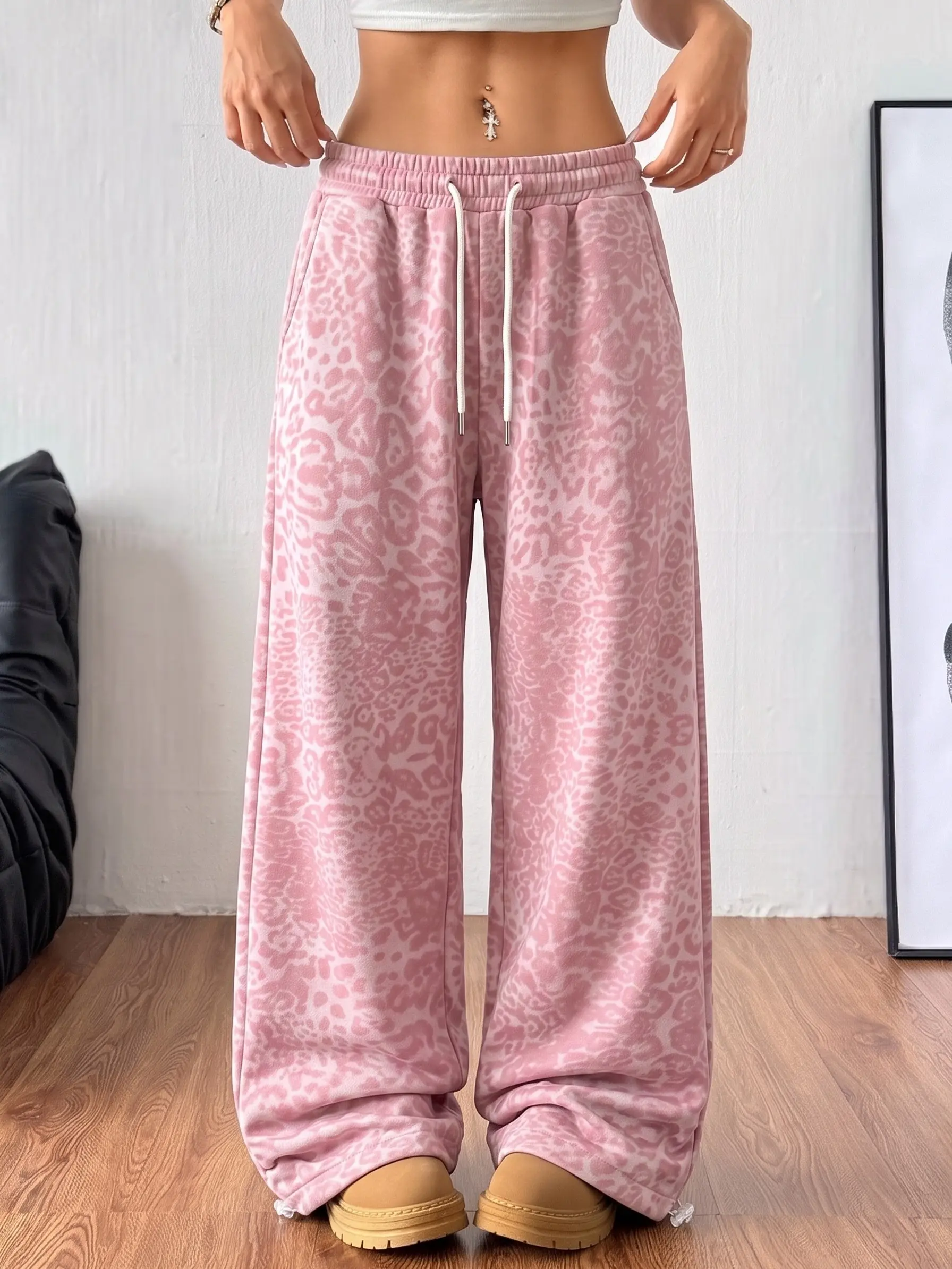 Women’s leopard print casual sweatpants featuring an elastic waistband with a drawstring, a loose wide straight-leg fit, adjustable drawcords at the pant hems, practical side cargo pockets, and a back patch pocket design.Cotton woven fabric is soft and sk