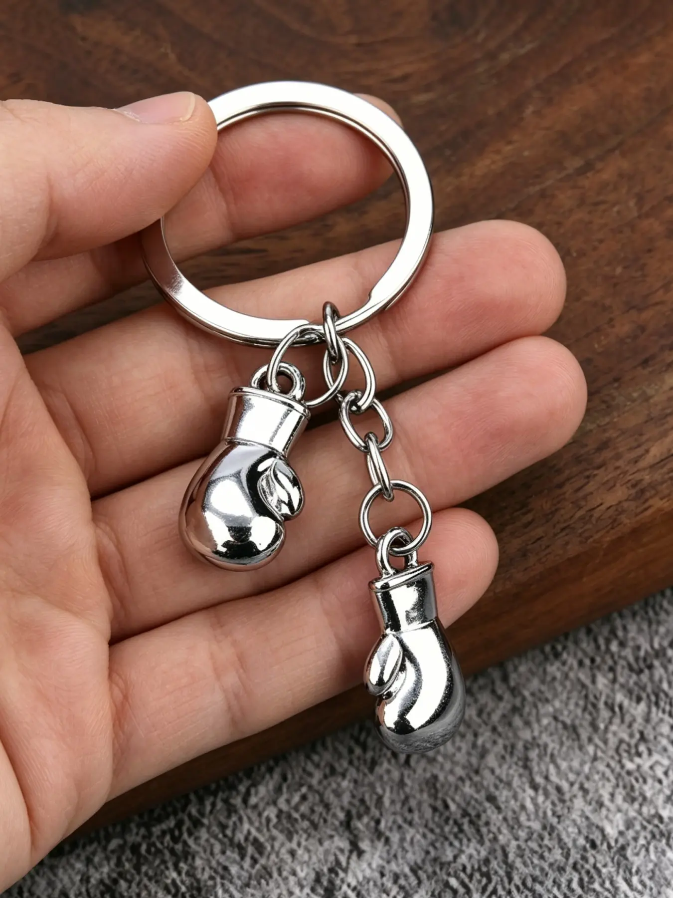 A fashionable mini boxing glove double button stainless steel keychain with a hardcore metallic texture, making every day full of strength and personality. Suitable for daily commuting, casual dressing, birthday gifts, and men's gifts