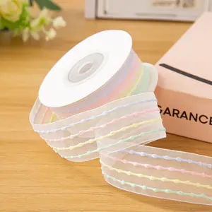A roll of rainbow-striped organza ribbon, 0.98 inches wide, featuring soft yet vibrant colors. This lightweight polyester material is ideal for gift wrapping as well as for festive decorations, such as those for Christmas.