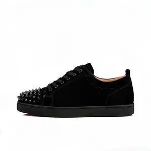 Fashionable and minimalist black suede low cut red soled sneakers with a red outsole and beige lining - a classic all black streetwear suitable for daily wear