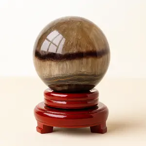 A hand-polished fluorite sphere with natural silk-like bands — ideal for focus, energy cleansing, and elegant home decor.