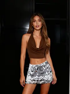 Christmas New Arrival! Slim-Fit Sexy Backless Short Top & Sparkly Sequin Skirt Set The set combines a slim-fit short top with a sexy backless design and a glittering sequin skirt. Shiny sequins catch the light brilliantly, while the tailored cut of the to