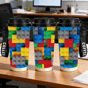 1pc 18oz insulated cup printed with a pattern of Lego blocks assembled together, with a black cup lid and a COFFEE hanging string design. This is a creative and portable water cup in a building-block style.