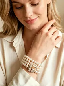 A vintage and elegant multi-layered pearl bracelet, adorned with central camellia and diamond accents that complement the pearls, perfect for daily commuting, vacation, and dating. It is also a delightful and exquisite small gift