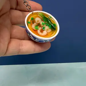Mini Bowl of Noodles Keychain – Adorable shrimp ramen-inspired food accessory with realistic details. Features noodles, shrimp, veggies, and broth in a tiny ceramic bowl.