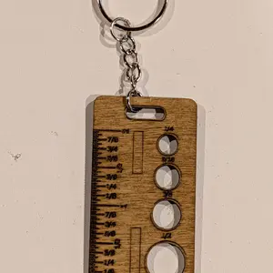 Ruler keychain with markings.