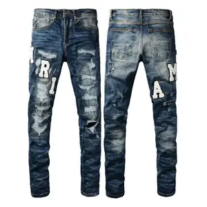 Men’s trendy slim-fit jeans from European and American high street fashion, featuring embroidered lettering, ripped patches, and stretch fabric