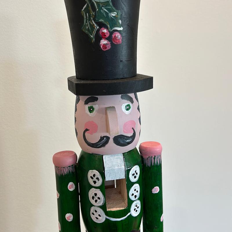 Hand-painted wooden nutcracker. He measures 24 inches tall. “Gunner” is a handsome guy that absolutely can live in your space year round.