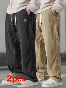 Two men's casual pants featuring a simple and versatile style with drawstring design, adding a casual feel. The pants have delicate small details, making them full of texture. The loose fit provides comfortable and relaxed wear, suitable for everyday outi