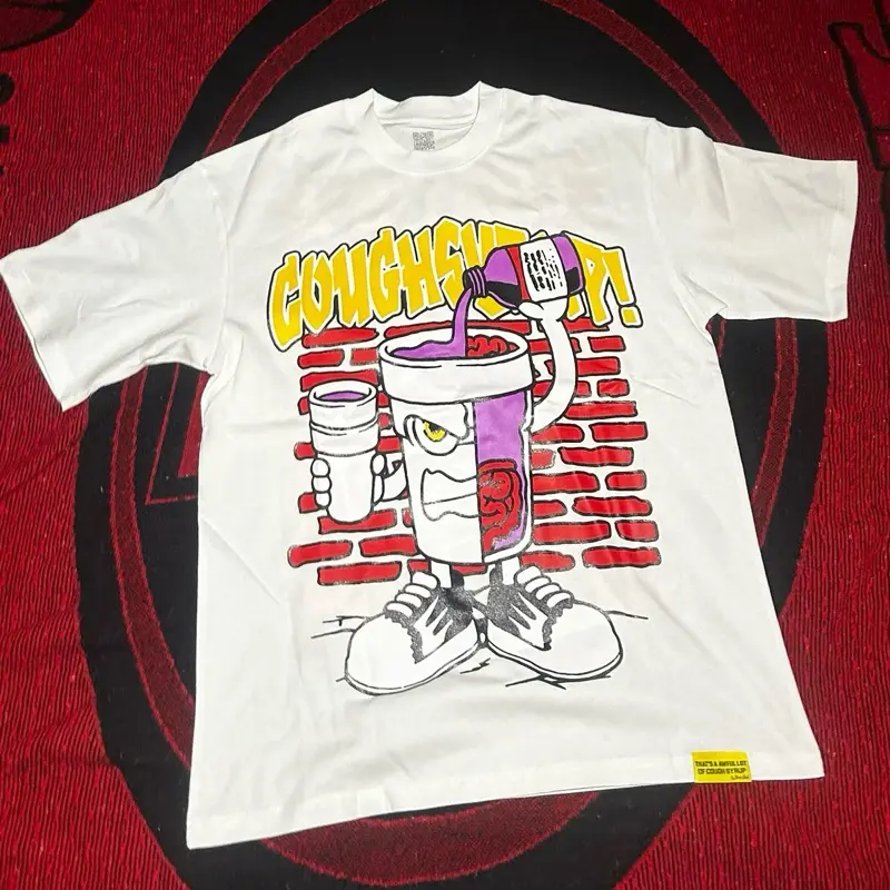 ALOC Tee - White T-Shirt with Unique Cartoon Design Featuring Coughsy Drink and Brick Wall Background for Casual Wear