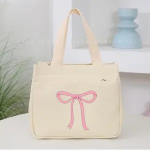 Mini multifunctional bag for carrying lunch, cosmetics, and small items; simple colors, large capacity, canvas material with printed pattern.