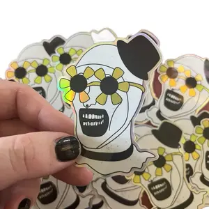 Terrifier Art The Clown Holographic Sticker - Colorful Skull Design with Sunflower Accents and Black Top Hat