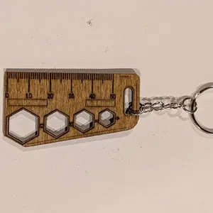 Ruler keychain with markings.