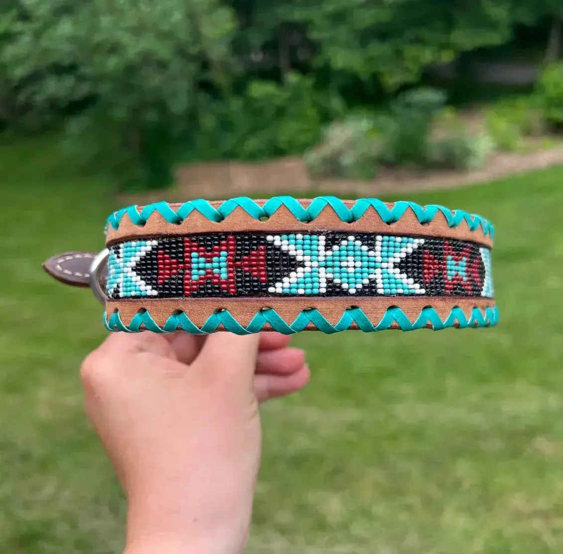 Genuine leather dog collar with teal, white, and burgundy beaded inlay design, a rawhide wrapped edge Genuine leather dog collar with teal, white, and burgundy beaded inlay design, a rawhide wrapped edge