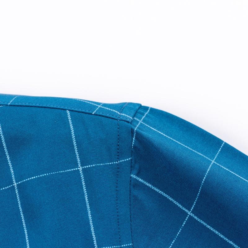 Men’s long-sleeve shirt with four plaid color-block panels, business-casual style. Button-down notched collar design for a sharp look, red buttons add refined details, blue-and-white plaid interior provides visual depth. Long-sleeve fit suitable for multi