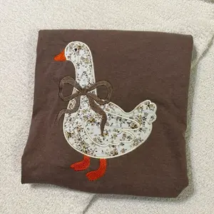Coquette goose appliqué embroidered Tshirt.