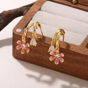 A pair of gorgeous pink teardrop-shaped flower earrings, sparkling with rhinestones, elegant and luxurious for an evening event.