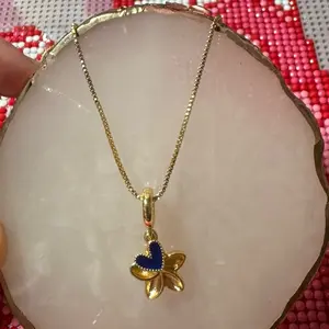 Flor de Sacuanjoche Necklace with Gold Design and Blue Heart Pendant Jewelry Item