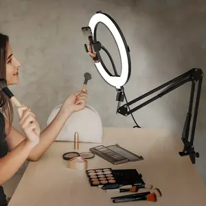 A 10-inch adjustable brightness round LED light with three color modes, powered via USB — ideal for live streaming, video recording, makeup, and photography — includes a phone holder, desktop stand, and clamp, offering exceptional flexibility! Perfect for