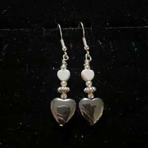 Navajo handmade sterling silver hook earrings featuring white halite, heart shaped hematite and silver daisy shaped beads.
