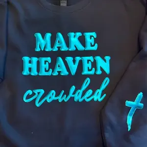 Woman's Make Heaven Crowded sweatshirt with a cross on the sleeve in Rose Gold Metallic or turquoise Puff Vinyl for Stylish Comfort