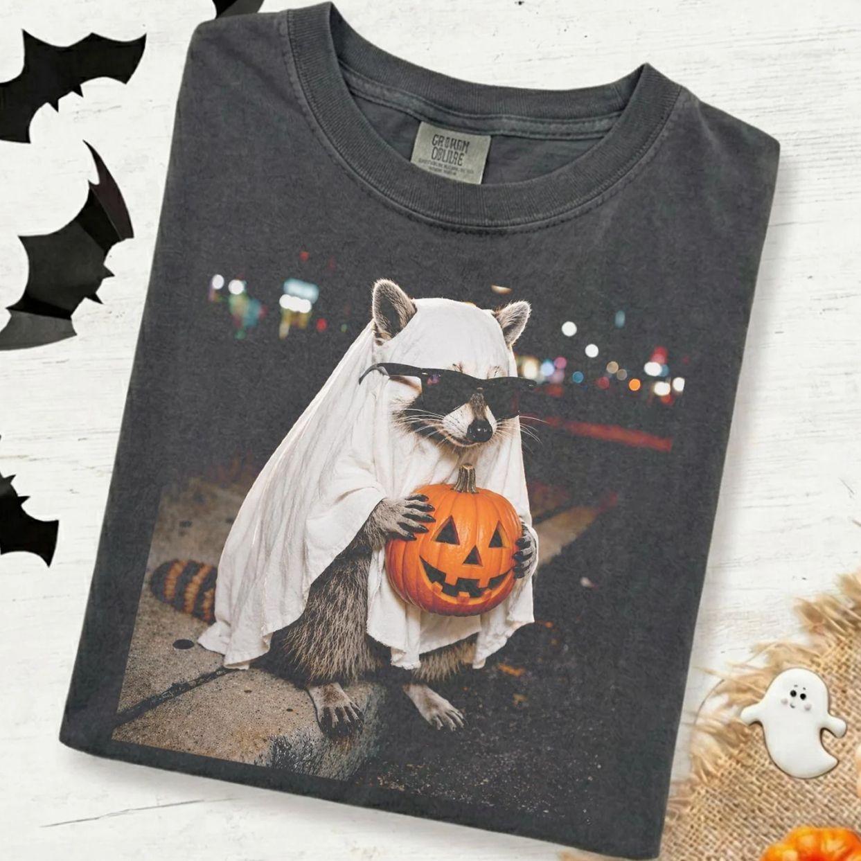 Comfort Colors Ghost Raccoon Halloween T-Shirt, Funny Raccoon Holding Pumpkin Shirt, Spooky Fall Animal Tee, Trending Halloween Graphic Tee, Comfortable Menswear & Womenswear Top, Perfect Gift For Men And Women, Aug1