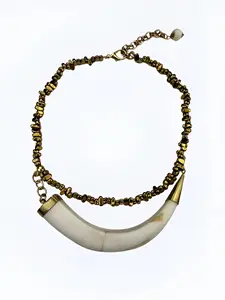 Handcrafted Brazilian necklace with horizontal horn pendant and gold-tone beads, lightweight boho chic jewelry.