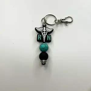 Cute trendy RN registered nurse keychain turquoise and black silicone beads. Beaded bar measures 3-1/2 inches long.