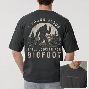 I Found Jesus Still Looking For Bigfoot Shirt, Funny Christian Sasquatch Graphic Tee, Breathable Cotton Unisex Casual Faith T-Shirt, Wilderness Camp Religious Gift Top