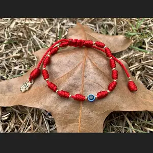 Handamde red evil eye with hamsa hand .