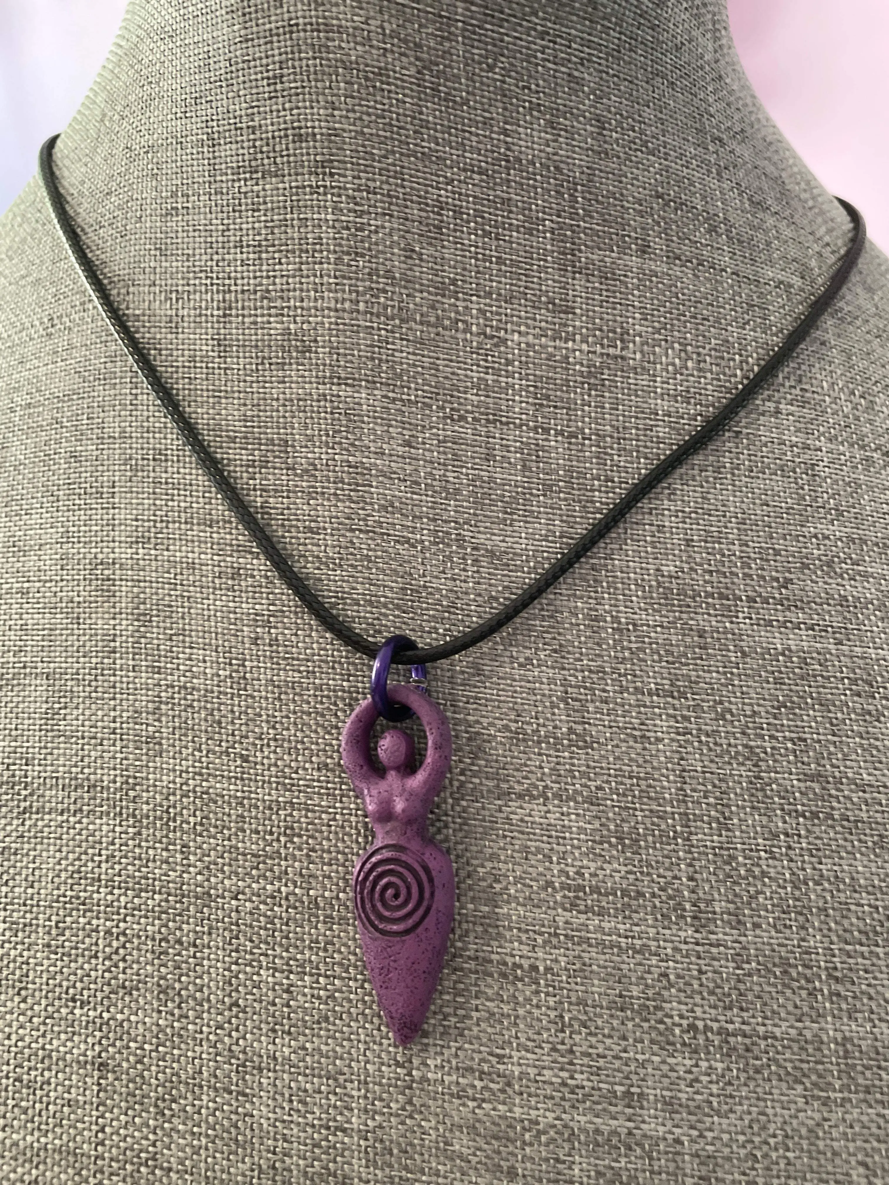 The Goddess pendant necklace on black cord.