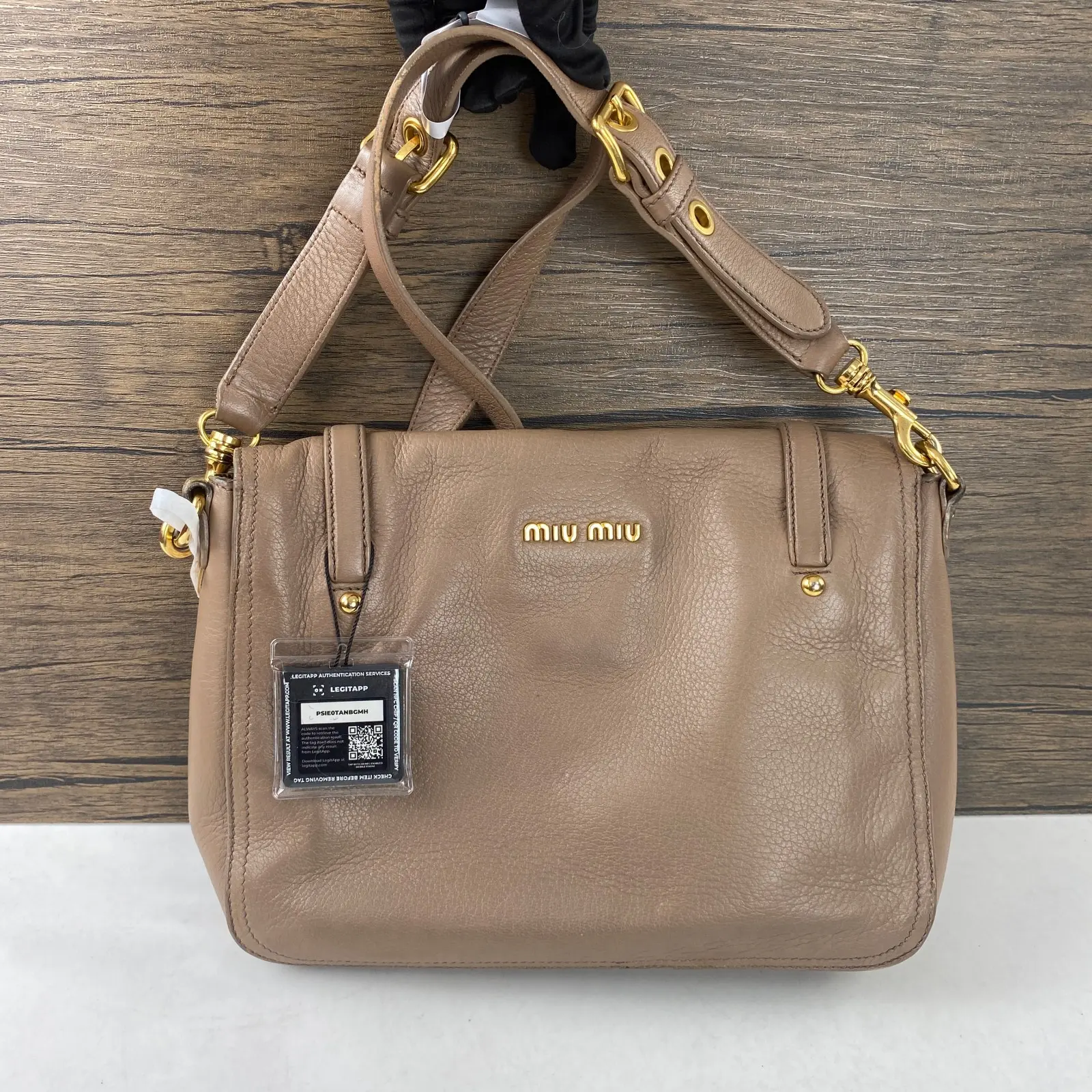 Pre-owned miu miu leather Backpacks taupe pebbled shoulder cross‑body bag with polished golden‑tone hardware+charm