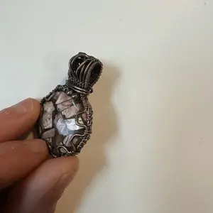 Rhodochrosite and copper pendant with obsidian accent wire wrapped in oxidized copper