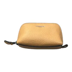 COACH Pebbled Leather Mini Cosmetic Clutch with Logo Zipper Closure for Women in Yellow