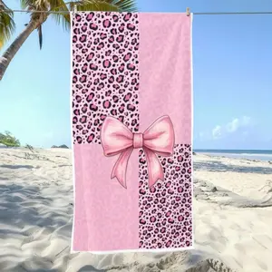 A Microfibre Beach Towel Featuring a Pink Leopard Print Design, Complete with a Large Bow. It'S Fashionable, Absorbent, And Perfect for Summer, Made from Quick-Drying Polyester