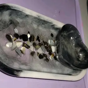 Resin tray with crushed shells embedded inside and a resin heart on top.