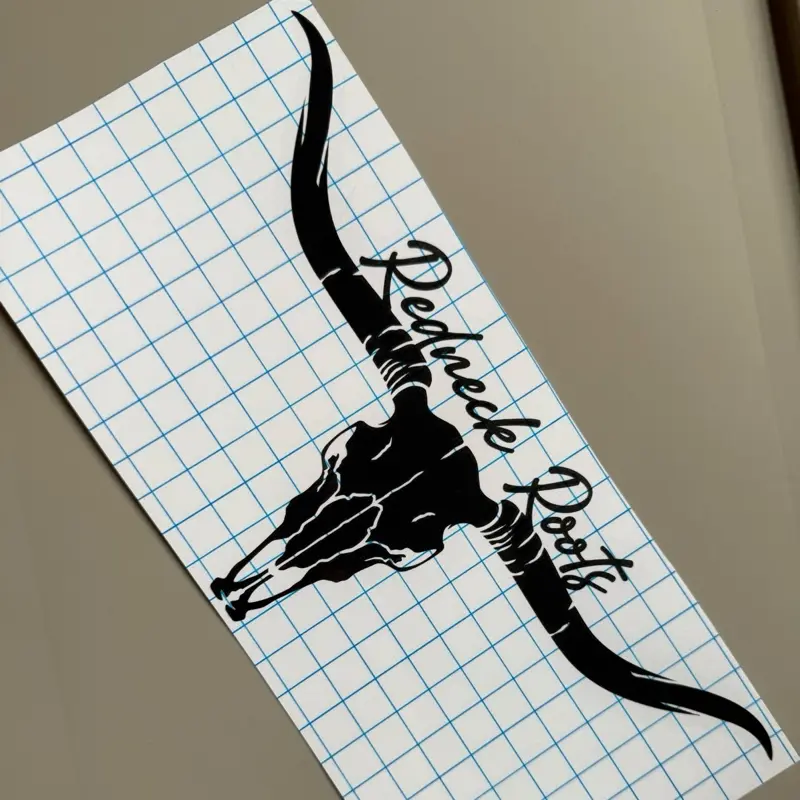 RedNeck Roots Brand Longhorn Skull Sticker - Black Graphic Design on Grid Paper Background